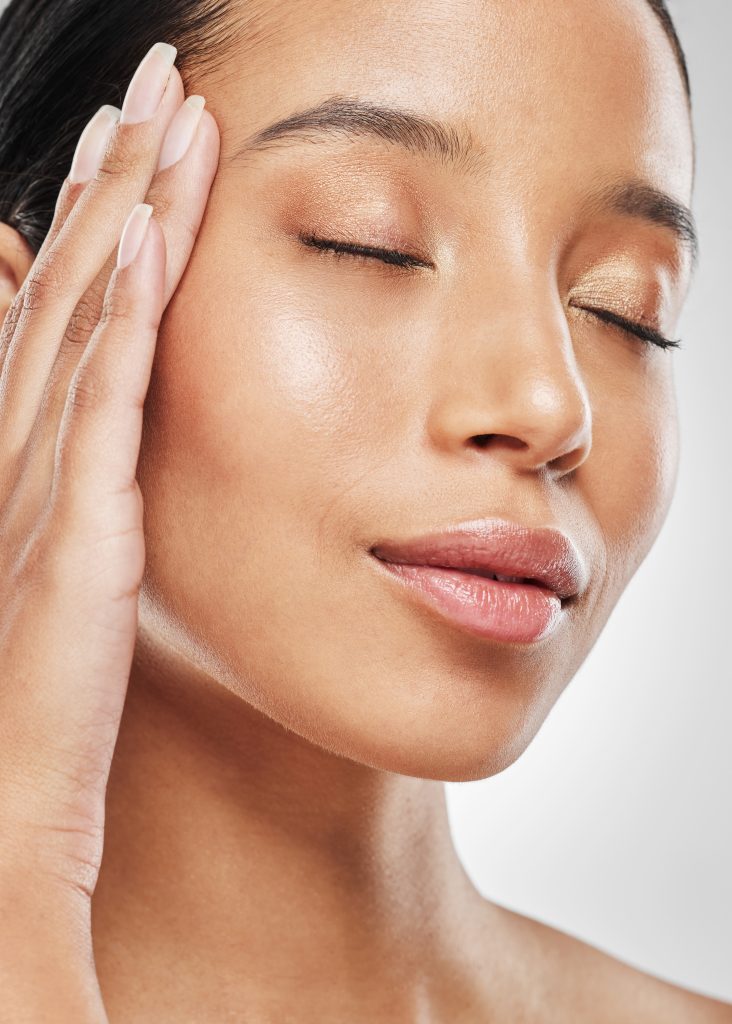Close-up of a woman with glowing, smooth skin after microneedling treatment at RAVE Clinics in Littleton, Colorado